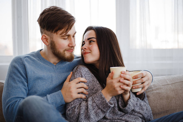 Couple drinking coffee in living room - Photo, image
