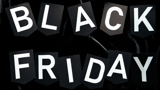 top view of black friday lettering on black background - Photo, Image