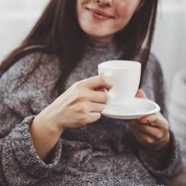 Cozy young woman enjoy morning coffee - Фото, зображення