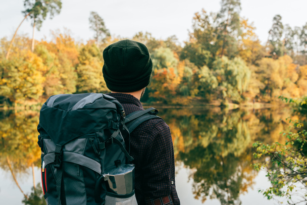 male traveller with backpack on autumnal background - Photo, Image