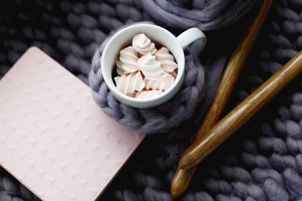 Closeup of cup of coffee placed over grey knitted pattern  - Fotografie, Obrázek