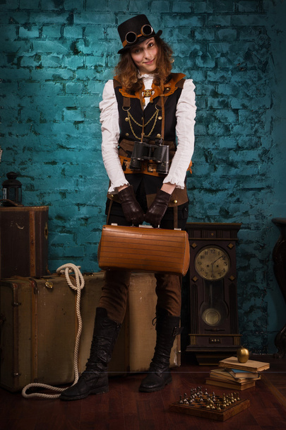 Steam punk girl with suitcase - 写真・画像