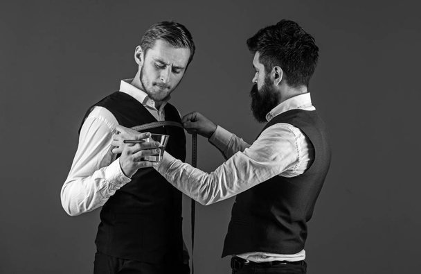 Tailor measure chest for sewing suit, grey background. - Fotoğraf, Görsel