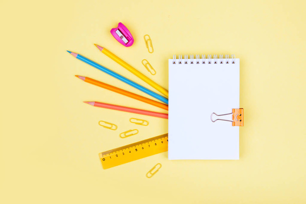 colorful school supplies on yellow background - Фото, изображение