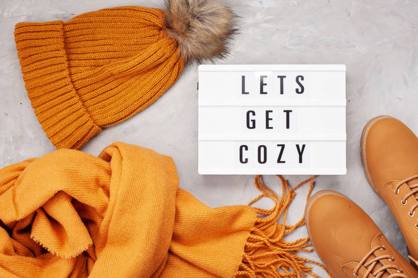 Flat lay with comfort warm outfit for cold weather. Comfortable autumn, winter clothes shopping, sale, style in trendy colors concept. Lightbox with the text Let's get cozy - Photo, Image