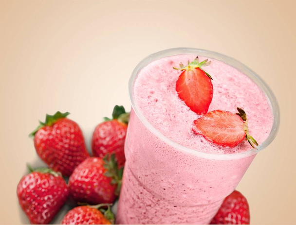 glass of fresh strawberry smoothie on wooden table - Fotografie, Obrázek