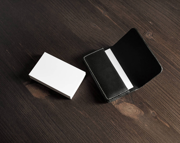 Blank business cards and leather business card holder on wooden background. - Photo, Image
