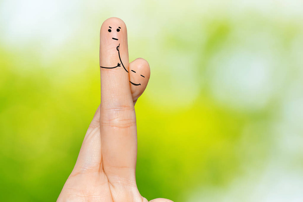 Human hand fingers with funny painted emoticons. People relationships concept - Photo, Image