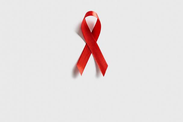top view of aids awareness red ribbon on white background - Fotografie, Obrázek