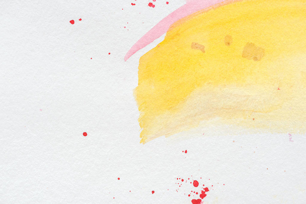 abstract background with yellow and pink watercolor strokes with red splatters - Photo, image