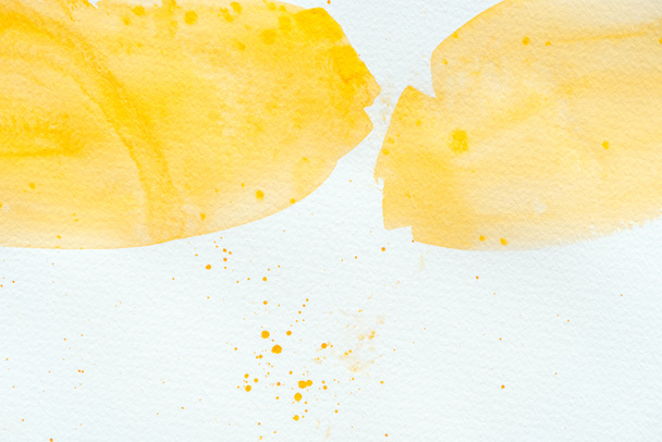 abstract yellow watercolor strokes on white paper - Photo, Image