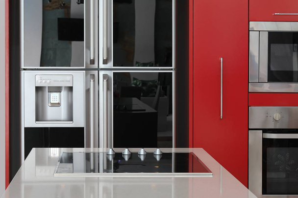 Interior design of modern black and red kitchen - Foto, afbeelding