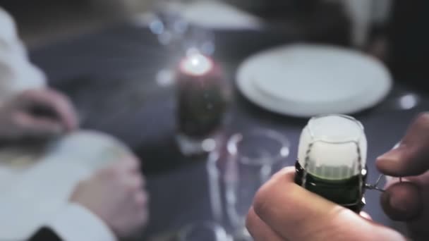 the waiter comes off the wire from the champagne cork and get ready to open it - Footage, Video
