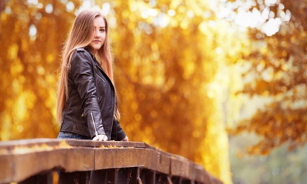 Beautiful young woman in the nature an autumn's day - Photo, image