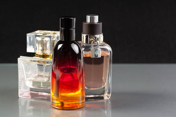 close up of  perfume bottles on a dark background - Foto, Imagem