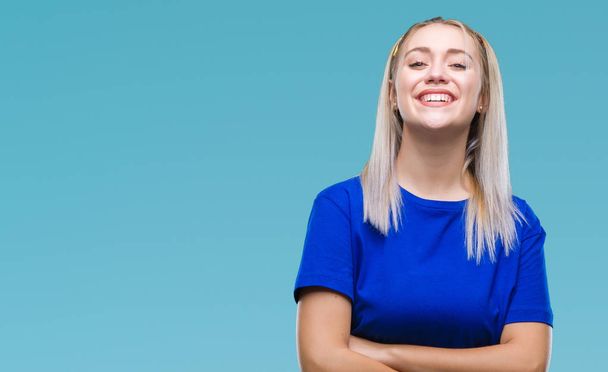 Young blonde woman over isolated background happy face smiling with crossed arms looking at the camera. Positive person. - Photo, Image