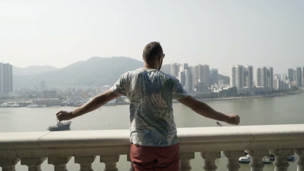 Young man admire cityscape standing on terrace in city - 映像、動画