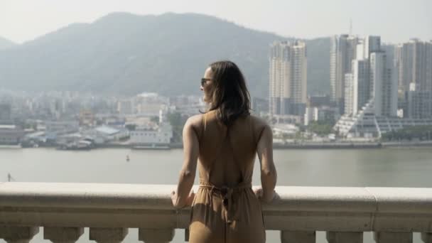 Young woman admire cityscape standing on terrace in city - Filmagem, Vídeo