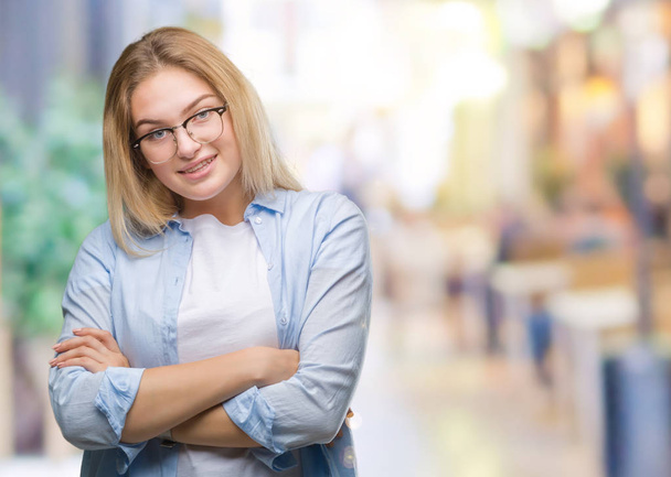 Young caucasian business woman wearing glasses over isolated background happy face smiling with crossed arms looking at the camera. Positive person. - Photo, Image