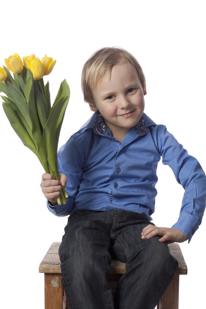 мальчик с тюльпанами смотрит в камеру
 - Фото, изображение