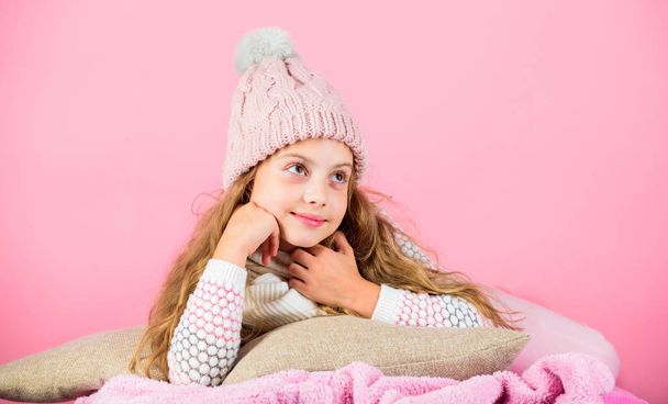 Kid dreamy wear knitted hat. Winter rest and relax. Winter season concept. Winter fashion accessory. Kid girl knitted hat and scarf. Winter accessory concept. Girl long hair dream pink background - Fotografie, Obrázek