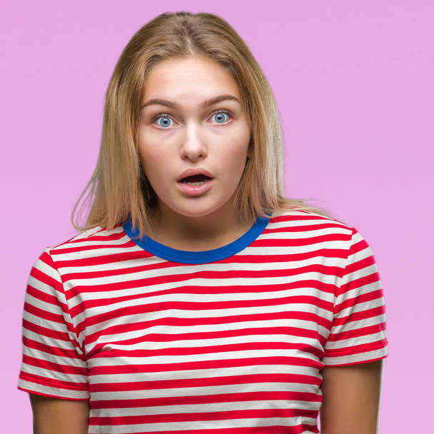 Young caucasian woman over isolated background afraid and shocked with surprise expression, fear and excited face. - Photo, Image