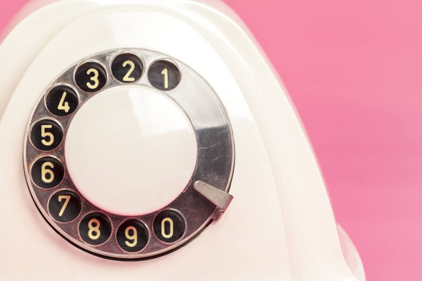 Retro white telephone on pink background - 写真・画像