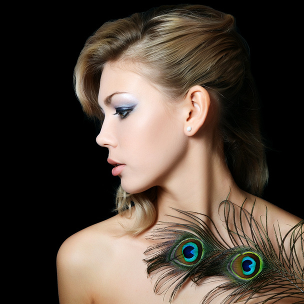 The beautiful woman with feathers of a peacock - Zdjęcie, obraz