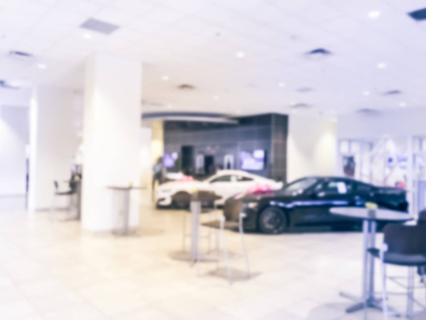 Blurred abstract inside car dealership with brand new cars and bow. Defocused car showroom in Texas, America - Photo, Image