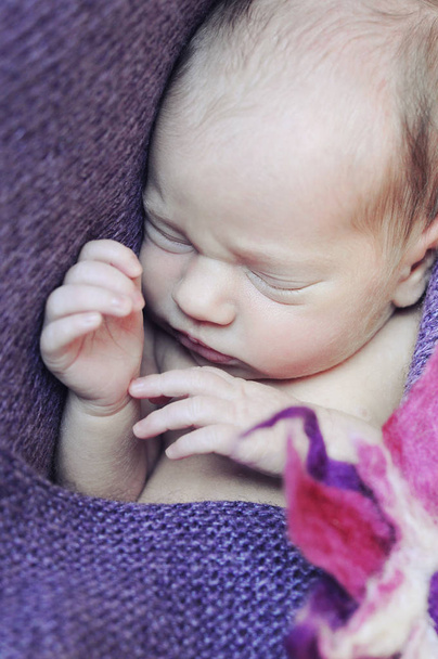 close-up newborn girl sleeping baby bright colors - Фото, изображение
