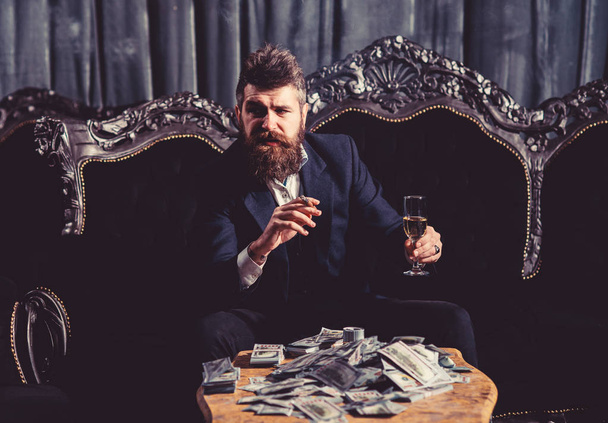 Millionaire in elegant suit smokes and drinks. - Φωτογραφία, εικόνα