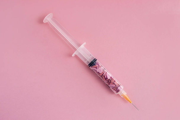 Syringe a full of sugar isolated on pink. Concept of diabetes.  - Fotografie, Obrázek