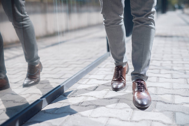 Close up businessman`s walking legs. Street exterior. - Foto, Bild