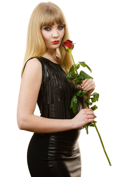 Flower, romantic people. Beautiful young lady with red rose. Long haired, blonde girl has black leather outfit. Woman has nice make up. - Photo, Image