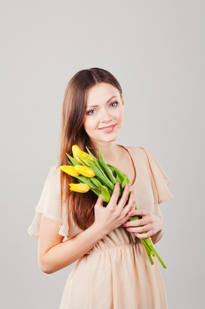 Portrait of beautiful woman with tulips - Zdjęcie, obraz