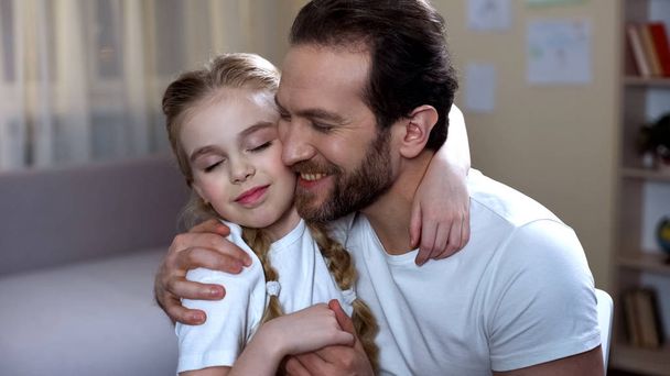 Loving father hugging his little pretty daughter, family care, happy parenthood - Фото, зображення