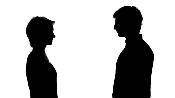 Silhouette of man and woman stand opposite, equal rights, social advertisement - Foto, Imagem