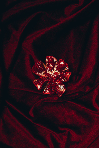 top view of cut garnate on red velvet cloth background - Foto, Imagem