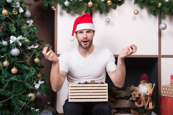 The morning before Xmas. delivery christmas gifts. happy santa man. online christmas shopping. New year scene with tree gift. man in santa hat hold christmas present. Merry Christmas. what is this - 写真・画像