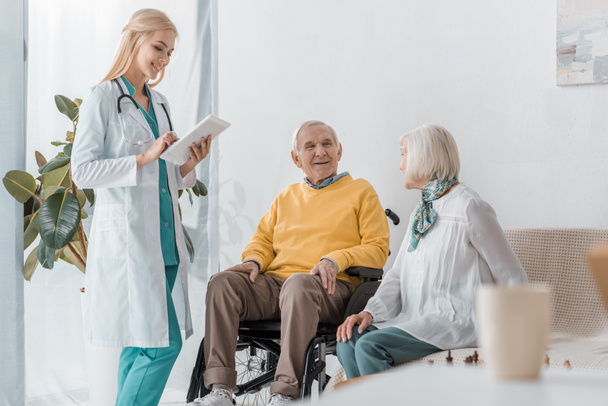 young smiling female doctor examining senior people at nursing home - Photo, image