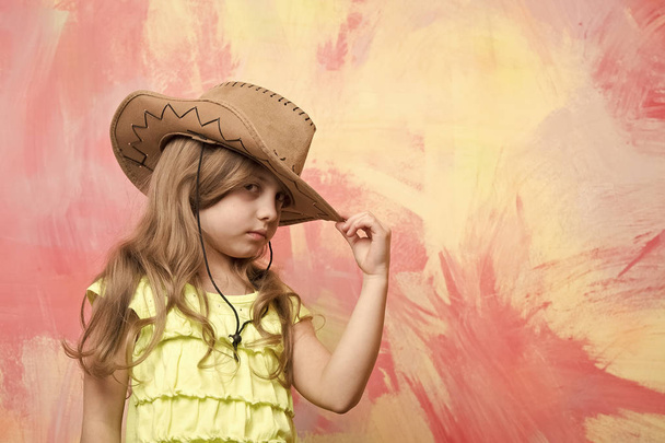 little girl in cowboy hat on colorful background, copy space. - Fotoğraf, Görsel
