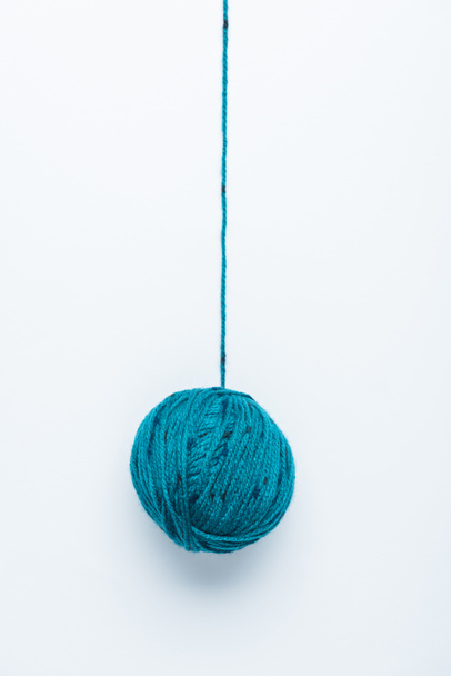 top view of blue yarn ball for knitiing on white backdrop - Fotoğraf, Görsel