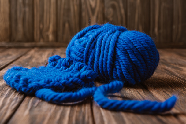 close up view of blue yarn for knitting on wooden surface - Fotó, kép