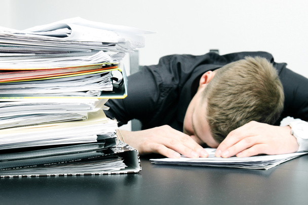 tired office worker and a pile of documents - Photo, Image