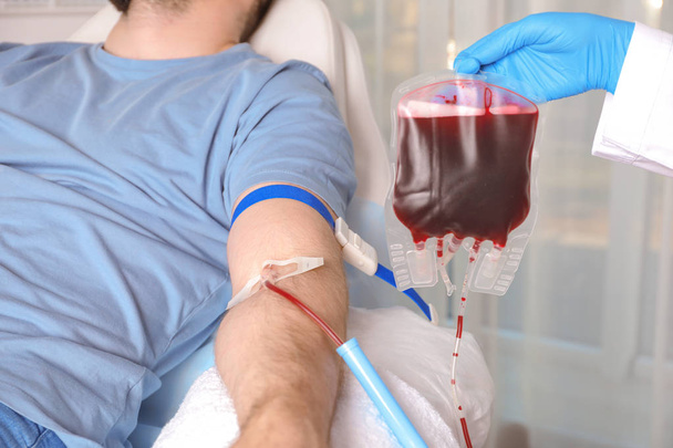 Man donating blood to save someone's life in hospital - Fotografie, Obrázek