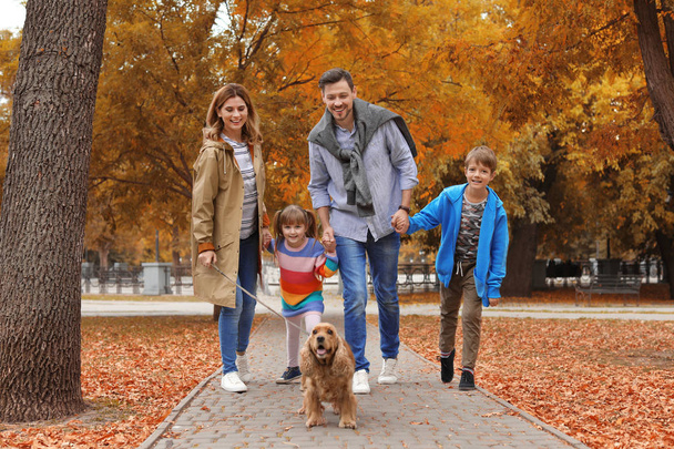 Happy family with children and dog in park. Autumn walk - Фото, изображение