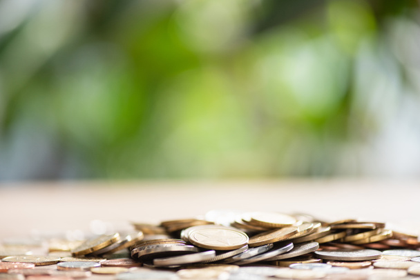 close-up view of pile of coins on tabletop and blurred background - Φωτογραφία, εικόνα