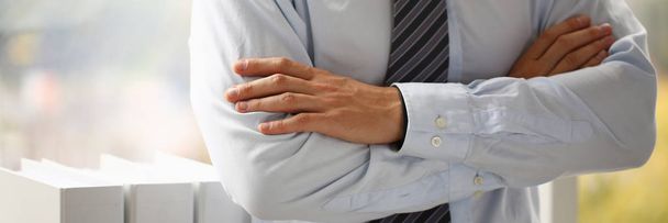 Male hands in suit crossed on chest closeup background - Foto, Imagen