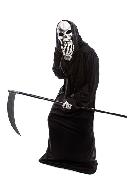 Halloween costume of a skeleton grim reaper wearing a black robe on a white background looking upset at making a mistake - Foto, Bild