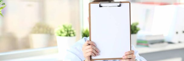 Businessman holds clipboard with paper - Photo, Image